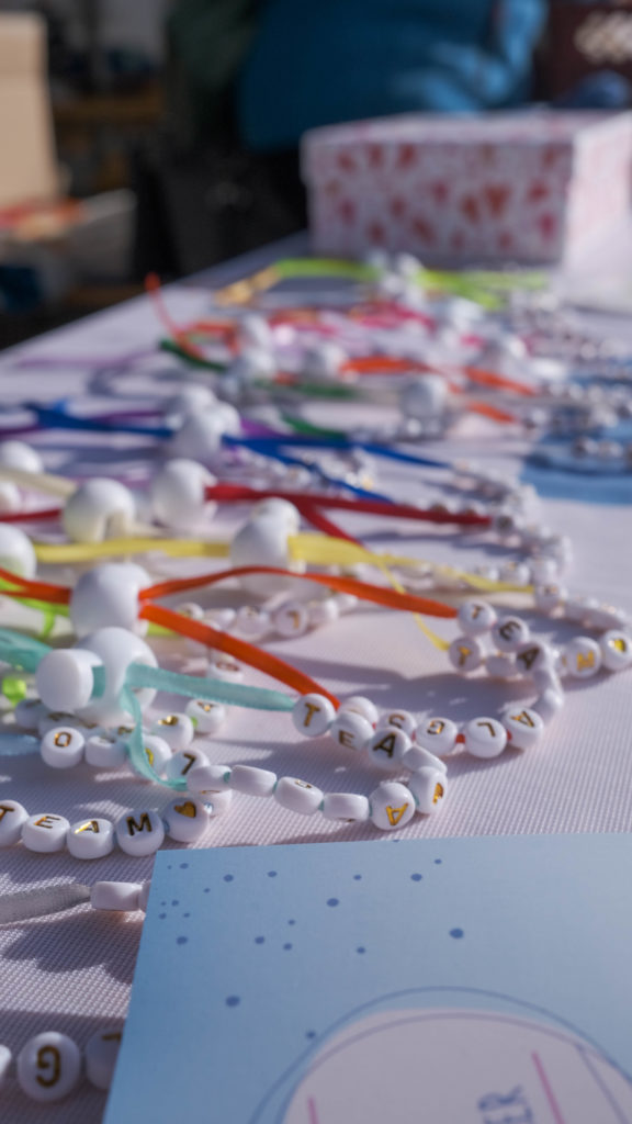 Team ALGSO bracelets in various colours laid out on the stand