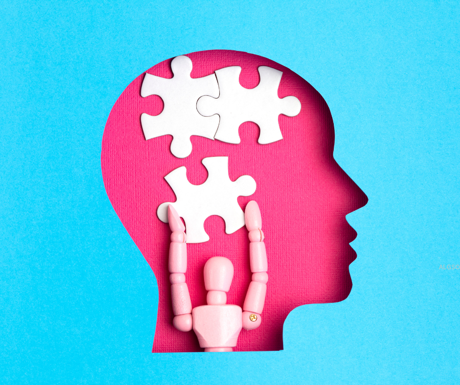 a pink toy figurine holding a puzzle piece inside the silhouette of a head