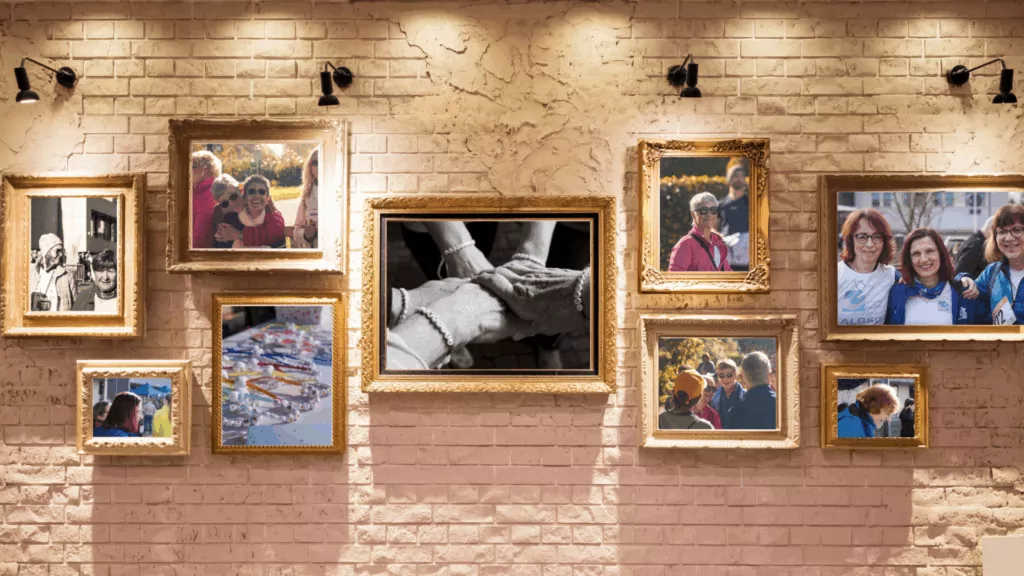 a group of framed pictures hung on a brick wall in a photo gallery